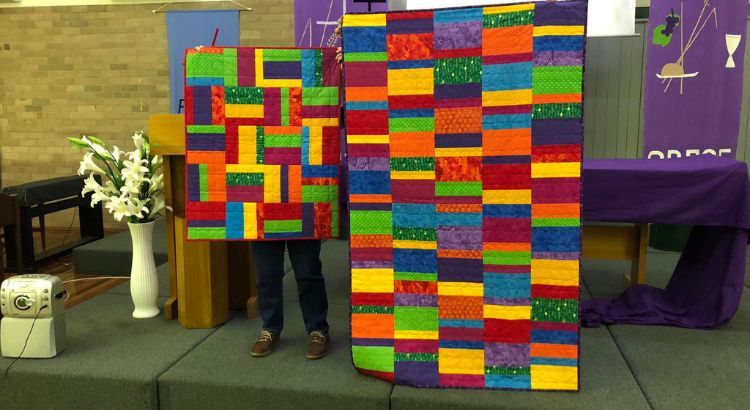 Some patchwork quilts being shown on display